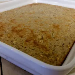 En gyllene protein ugnspannkaka i en vit form, redo att serveras.